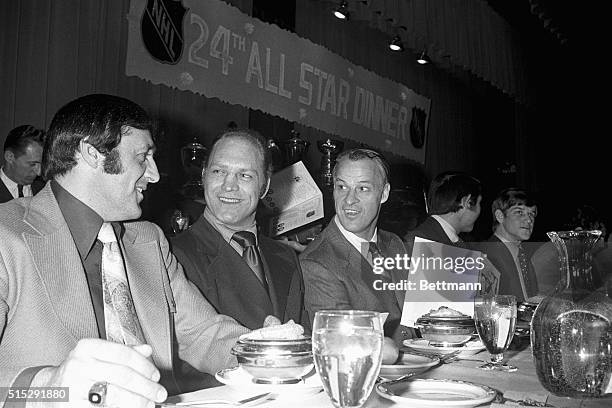 Enjoying a light moment at the 24th All Star Dinner are Phil Esposito of the Boston Bruins, Bobby Hull of the Chicago Black Hawks and Gordon Howe of...