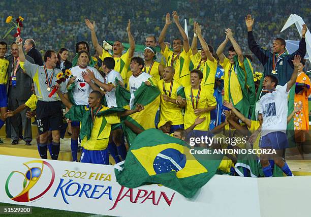 The whole Brazilian team celebrates on the pitch during the award ceremony at the International Stadium Yokohama, Japan, 30 June, 2002 following...