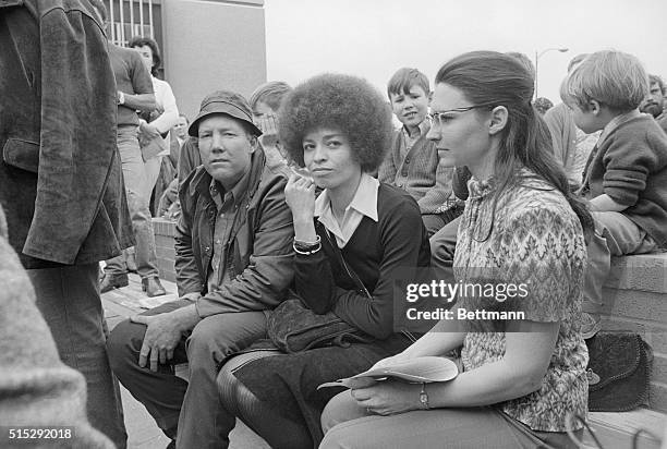 Angela Davis awaits her murder-kidnap trial outside courthouse today.