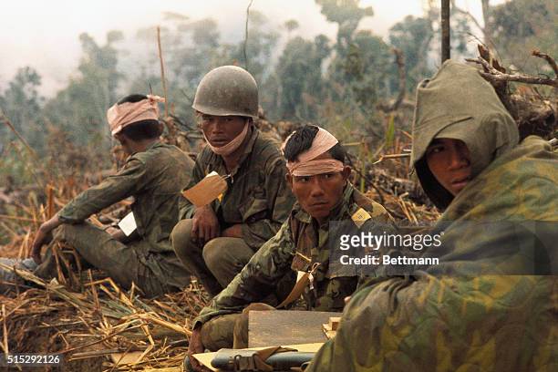 Wounded Vietnamese Rangers await medivac chopper at Landing Zone "Phu Loc" about 1 km from the Laotian border.