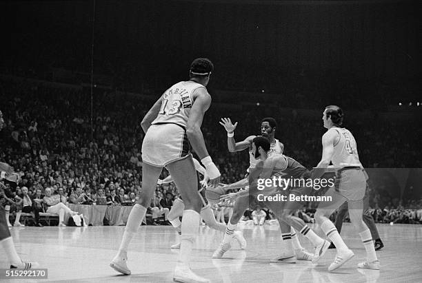 Inglewood, California: New York Knicks' Walt Frazier is surrounded by a group of Lakers as he moves in to take a pass during first quarter action May...