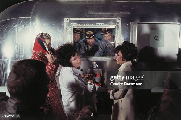 Space Center, Houston: Apollo 14 astronauts Alan Shepard, Edgar Mitchell and Stuart Roosa, in quarantine trailer, are welcomed home by their wives...