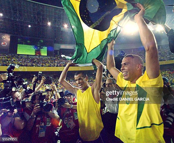 Brazil's midfielder Rivaldo celebrates with teammate Ronaldo after their team defeated Germany 2-0 in the final match of the 2002 FIFA World Cup...