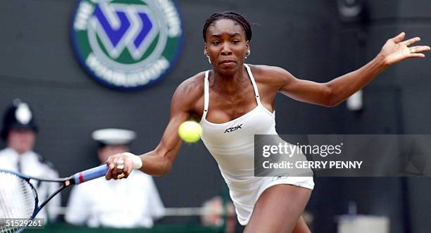 Venus Williams plays a forehand during her fourth round match against compatriot Lisa Raymond at the Wimbledon Tennnis Championships, 01 July 2002....