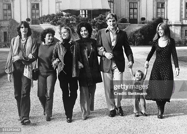 Elizabeth Taylor and John Warner walk arm in arm with their children from a variety of marriages after they announced their engagement.