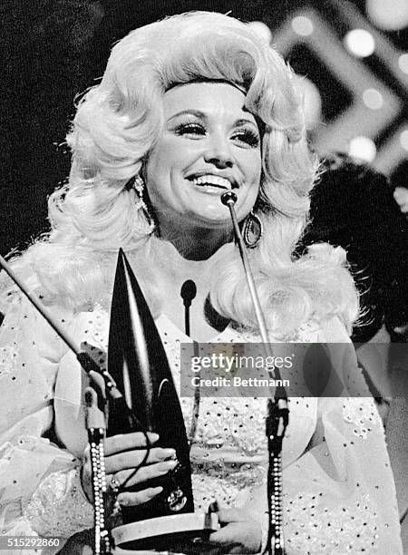 Dolly Parton radiantly accepts the award as "Female Vocalist of the Year" during this Country Music Association's televised awards show 10/13 night.