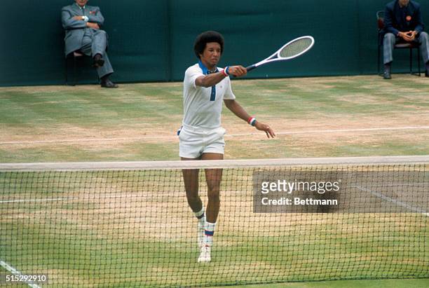 American tennis player Arthur Ashe grimaces as he hits a return to American Jimmy Connors during their 7/5 men's singles title match at Wimbledon....