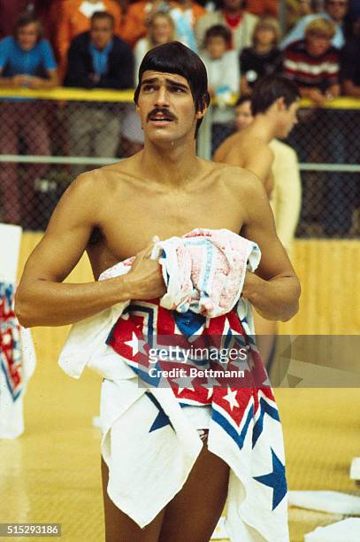 Mark Spitz, of the U.S. Olympic team, drying off during competition at the Munich Olympics, 24th August 1972.