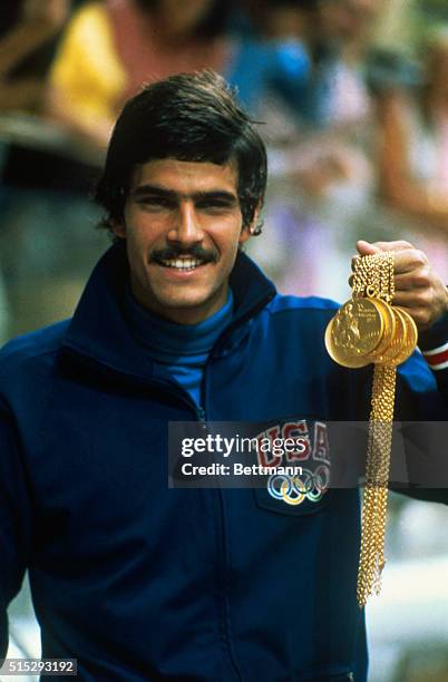 Swimmer Mark Spitz proudly displays the five gold medals he won in the 1972 Summer Olympics.
