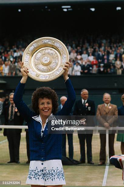 Jubilant Billie Jean King holds her winning trophy over her head 7/4. Billie Jean wound up her singles career with one of her greatest triumphs, a...