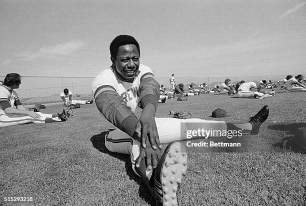 Hank Aaron, who broke Babe Ruth's home run record last year while playing with the Atlanta Braves, works out for the first time as a Brewer as the...