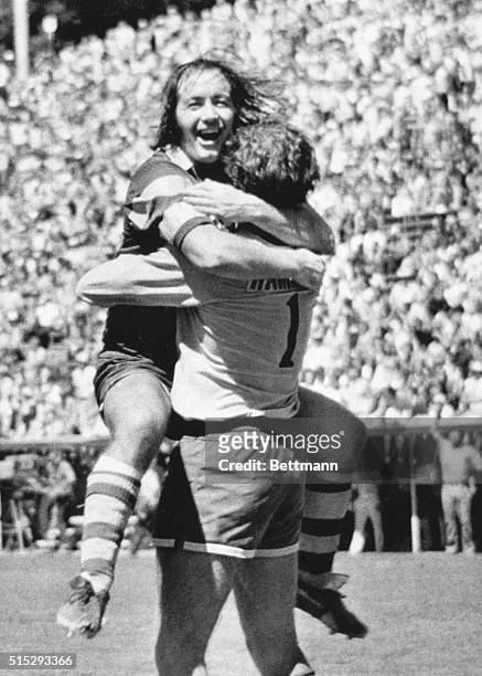 August 25, 1975 - San Jose, California; John Boyle, Captain of the Tampa Bay Rowdies, surrounds his goalkeeper Paul Hammond in a victory hug after a...