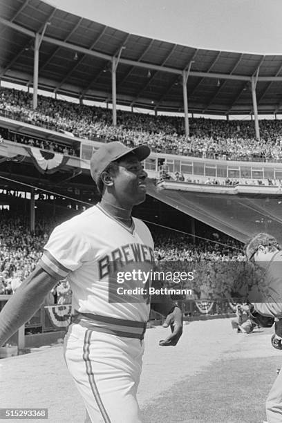 Milwaukee Brewers designated hitter Hank Aaron was all smiles as he walks on the field during "Welcome Home Henry" ceremonies at Milwaukee Country...