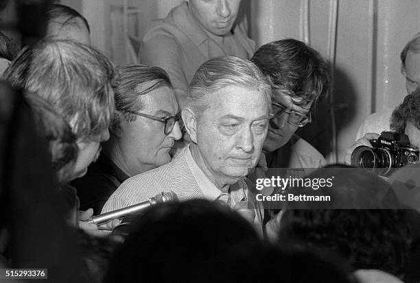 Ambassador to South Vietnam shows grim face as he surrounded by press men on the USS Blue Ridge in the South China Sea, 4/30. He abandoned the US...