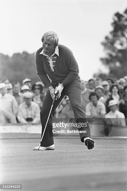 Jack Nicklaus coaxes a birdie putt into the cup of the front nine of second round Masters play. Nicklaus grabbed a 5 stroke lead with a red hot five...