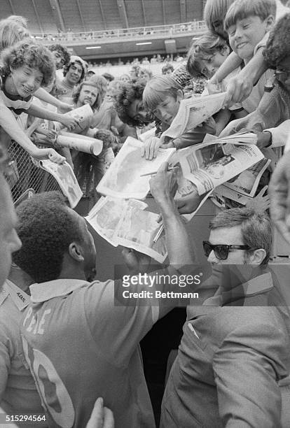 International soccer star Pele of the New York Cosmos signs autographs for the fans at RFK Stadium 6/29 following his team's win over the Washington...