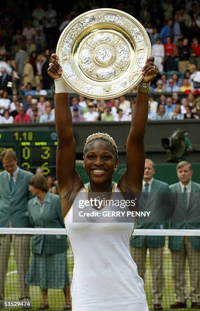 Serena Williams lifts the trophy after winning the Women's final against her sister Venus at the Wimbledon Tennis Championships, 06 July 2002. Serena...