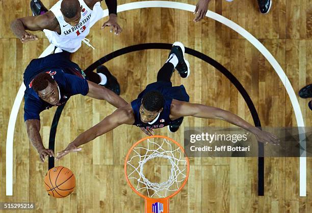 Marvelle Harris and Paul Watson of the Fresno State Bulldogs go up for a rebound against the San Diego State Aztecs during the championship game of...