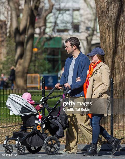 Chelsea Clinton and Marc Mezvinsky with daughter Charlotte Mezvinsky are seen on March 12, 2016 in New York City.