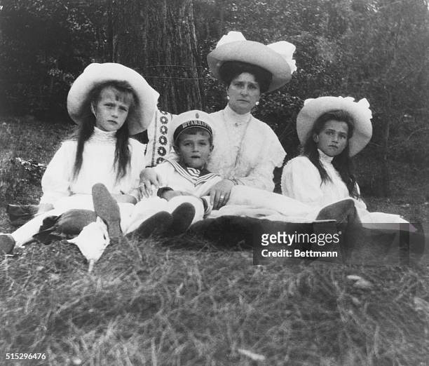 The Empress Alexandra with her three youngest children. Anastasia is on her right and Maria is on her left. Alexis in his mother's arms. Photo was...