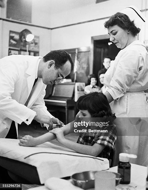Jonas Salk injects children with his polio vaccination during 1954 field trials in Pittsburgh