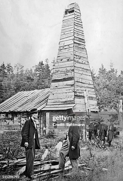 Edwin L. Drake in front of the first oil well in the U.S., which he drilled. To the left is Peter Wilson.