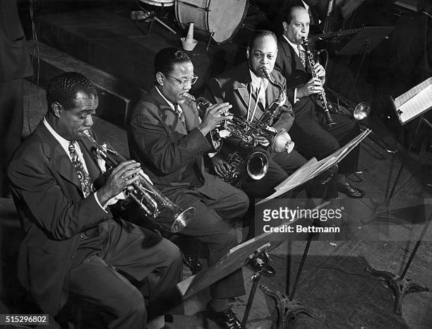 American jazz musicians Louis Armstrong, Roy Eldridge, Coleman Hawkins, Barney Bigard during a concert.