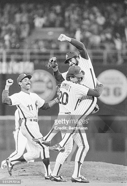 Philadelphia, PA- Phillies' relief pitcher Al Hlland leaps into the arms of third baseman Mike Schmidt as they defeated the Dodgers to win the...