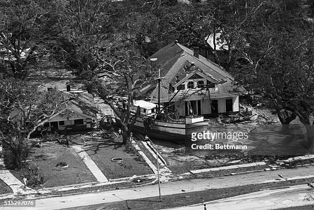Biloxi, MS-The Shrimper "Wade Klien" rests against a house that fronts the beach 8/18 where it was deposited by hurricane Camille.
