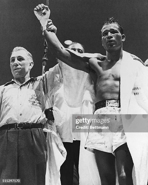 Chicago, IL: Sugar Ray Robinson was declared winner of middleweight championship bout with Jake LaMotta. Referee Frank Sicora holds up Robinson's arm...