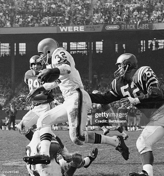 Browns fullback Jim Brown runs over Philadelphia Eagles' offensive tackle Gene Hickerson on his way to a first down during a game at Cleveland...