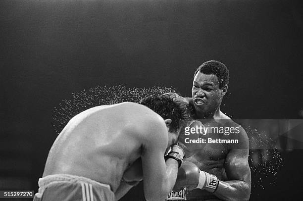Scranton, Pennsylvania- Larry Holmes blow to Frenchman Lucien Rodriguez causes his back to fly off with water as they battle in the fourth round in...