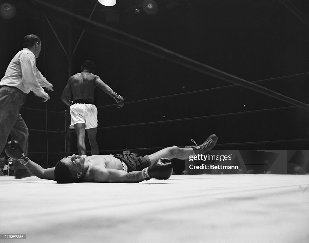 Boxer on Ground as Ray Robinson Walks Away