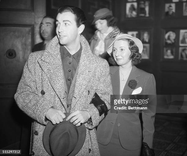 Los Angeles, CA: Robert Taylor and Barbara Stanwyck, pictured as they arrived to attend a preview of the "Country Doctor," a film dealing with the...