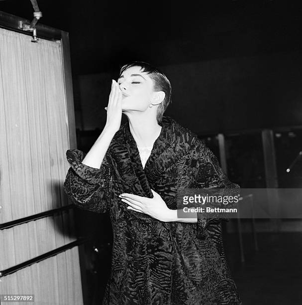 New York, NY- Audrey Hepburn, in complete costume and makeup, throws a kiss to the crowd gathered at New York's Center Theater on March 25, where the...