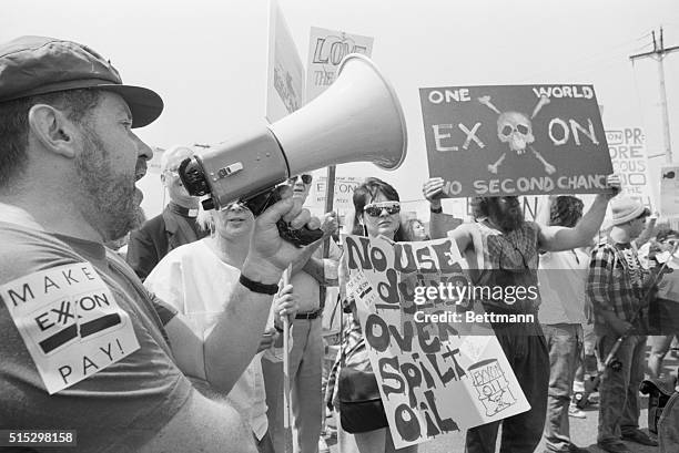 Parsippany, NJ- Protesters, some of them chanting "Make Exxon pay," greet Exxon shareholders outside the hotel here where company officials addressed...
