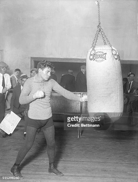 New York, NY- Photo shows Tony Canzoneri, leading bantamweight of the East, as he punched the heavy bag at Stillman Gym here preparing for his coming...