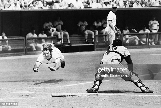 Cincinnati, Ohio- Pete Rose of the Reds dives into home plate past the glove of Giants' catcher Dave Rader, July 30th, in first game of...