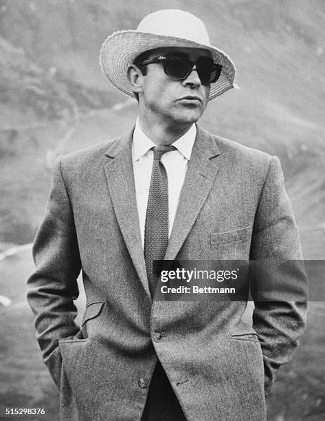 London, England- Though you would never guess it, the chap underneath the straw hat and sunglasses is Sean Connery, the movies' intrerpid "James...