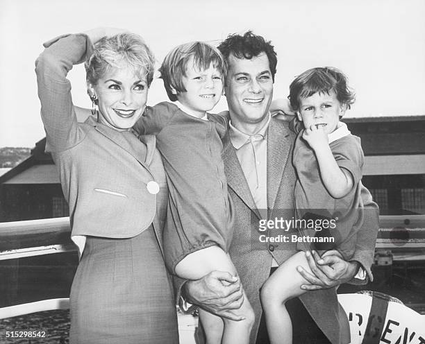 New York, New York- Tony Curtis and Janet Leigh with their children, Kelly and Jamie, 2 1/2, pose prettily prior to their departure on the...