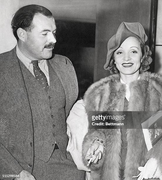 Ernest Hemingway arrives from European trip with friend Marlene Dietrich.