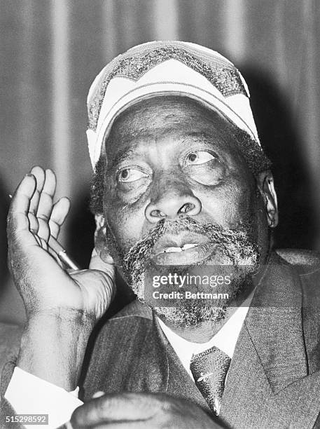 London- Jomo Kenyatta,African nationalist leader,cocks his ear during a press conference.Kenyatta is here to press for Kenya's independence.The...