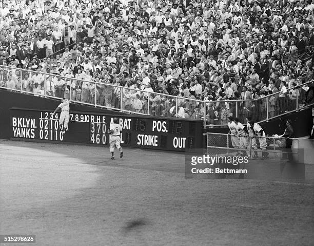 New York, New York- Dodger centerfielder Duke Snider leaps in vain for Yankee Joe Collins' homer in the sixth inning of the World Series at the...