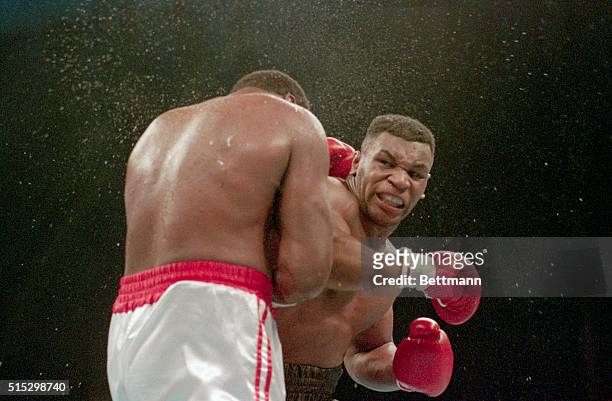 Atlantic City, NJ Ferocious faced Mike Tyson lands the knockout punch to the jaw of challenger Larry Holmes during fourth round of the World...