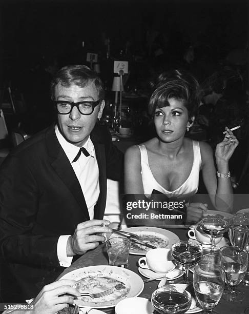 Ca. 1960-1970-ORIGINAL CAPTION READS: The newest combination in town is Nancy Sinatra and British actor Michael Caine. Doesn't he look impressive and...