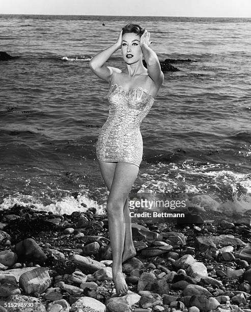 Shimmering like a silver mermaid, any girl would be the hit of the beach in this unusual bathing suit. Bodice flares out like the sea-shell pattern...