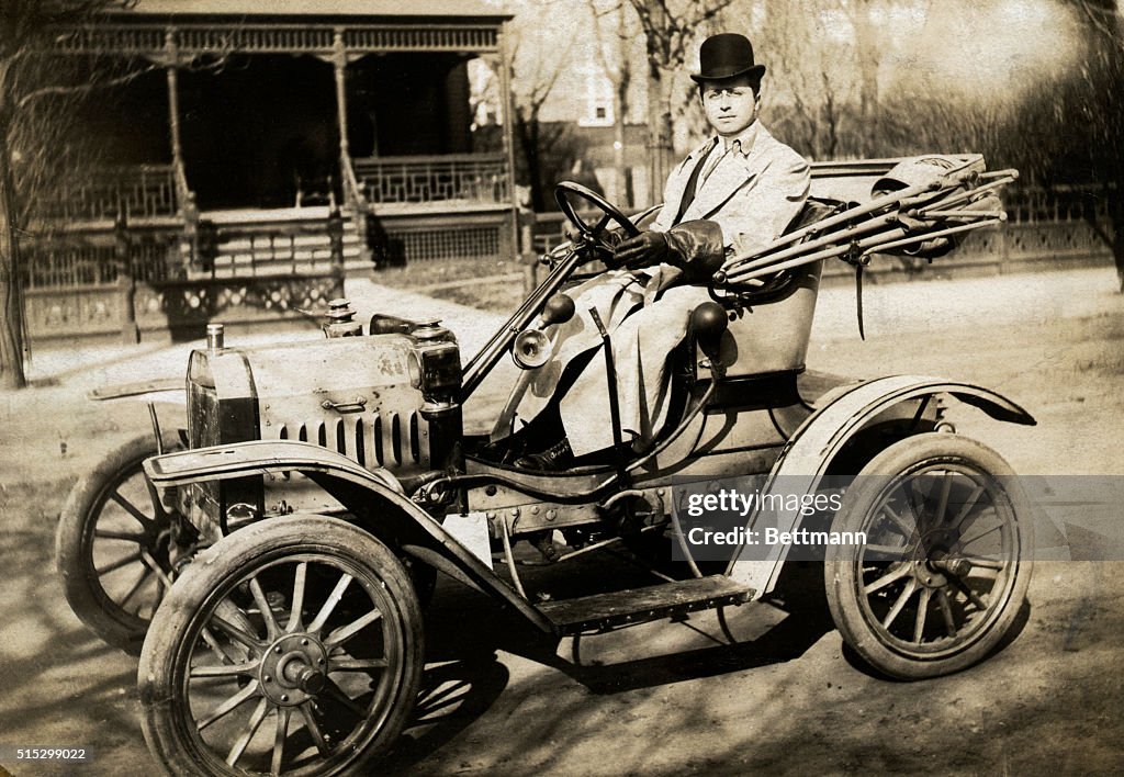 Man Driving One-Cylinder Brush Automobile