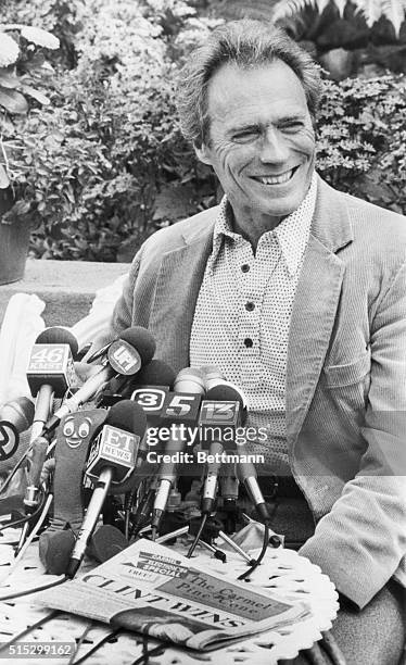 Carmel, CA- With a newspaper with a headline proclaiming his being new Carmel Mayor on the outdoor table, Clint Eastwood holds his first press...