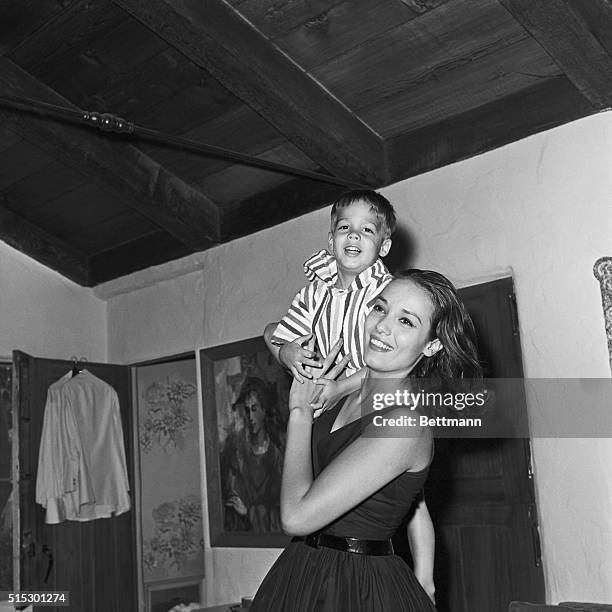 Hollywood, CA-Actress Anna Kashfi, ex-wife of actor Marlon Brando, hoists their three year-old son, Christian Devi Brando, off to bed in their modest...