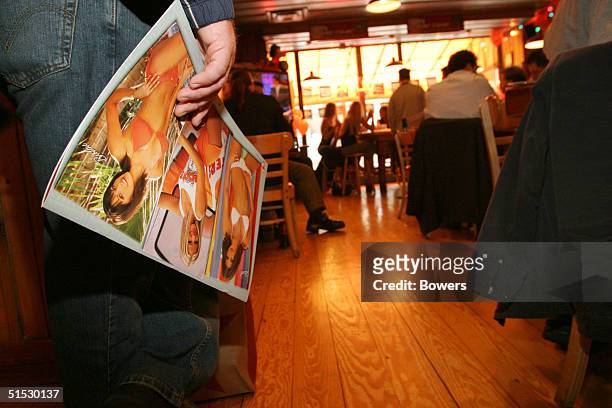 Customer waits in line at a Hooters girls calendar signing event at Hooters restaurant October 21, 2004 in New York City.